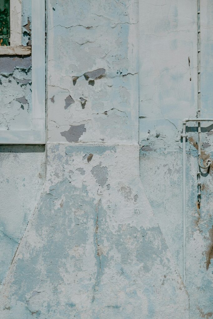 Weathered cracked plaster wall before protective coating